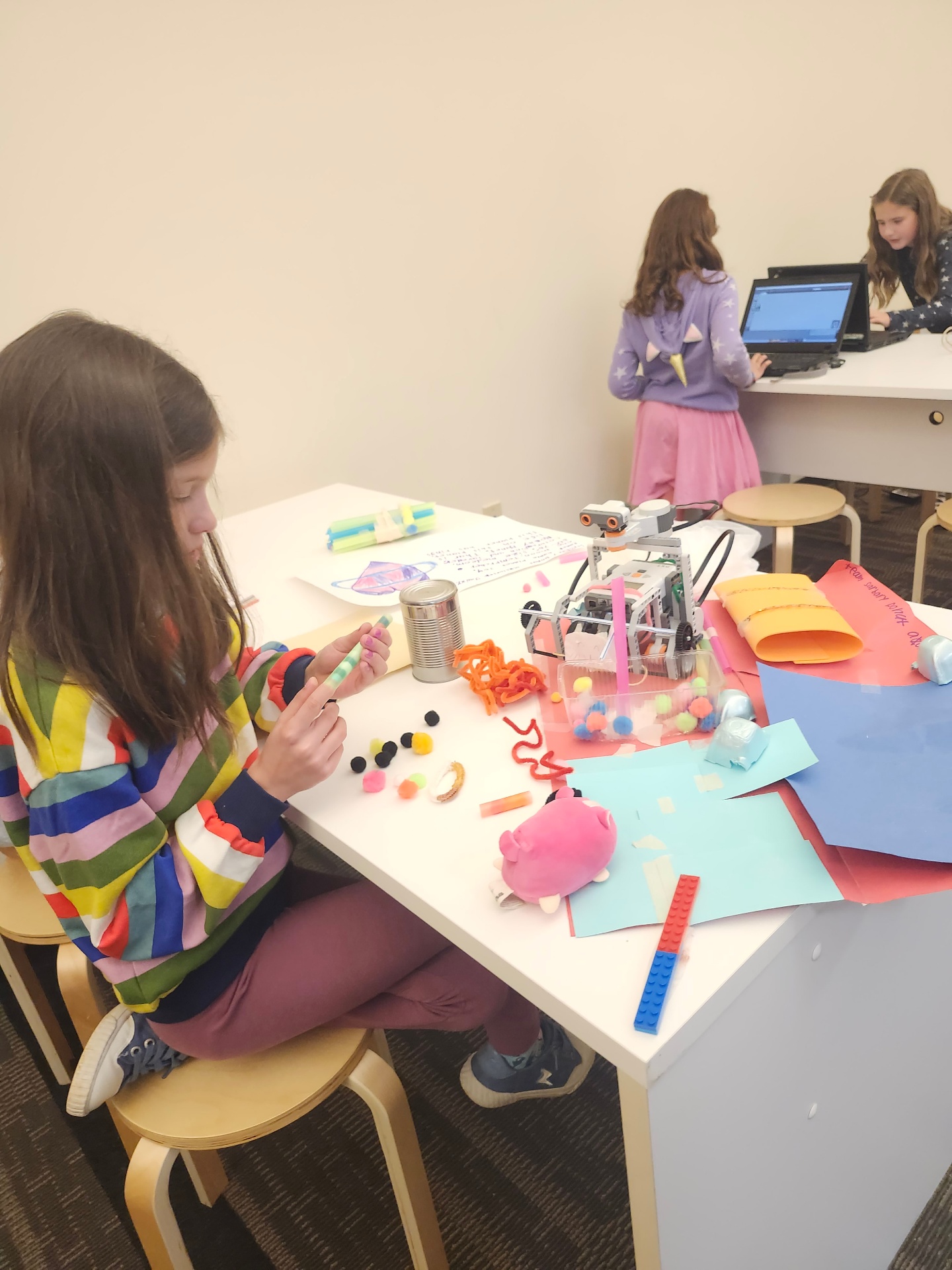 Students making crafts and building with LEGO robotics